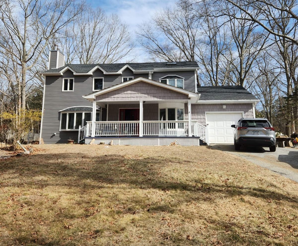 Rebuilt two-story home with a white porch