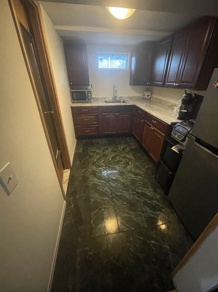 After: new kitchen with cherry cabinets, stone counters and tile floor