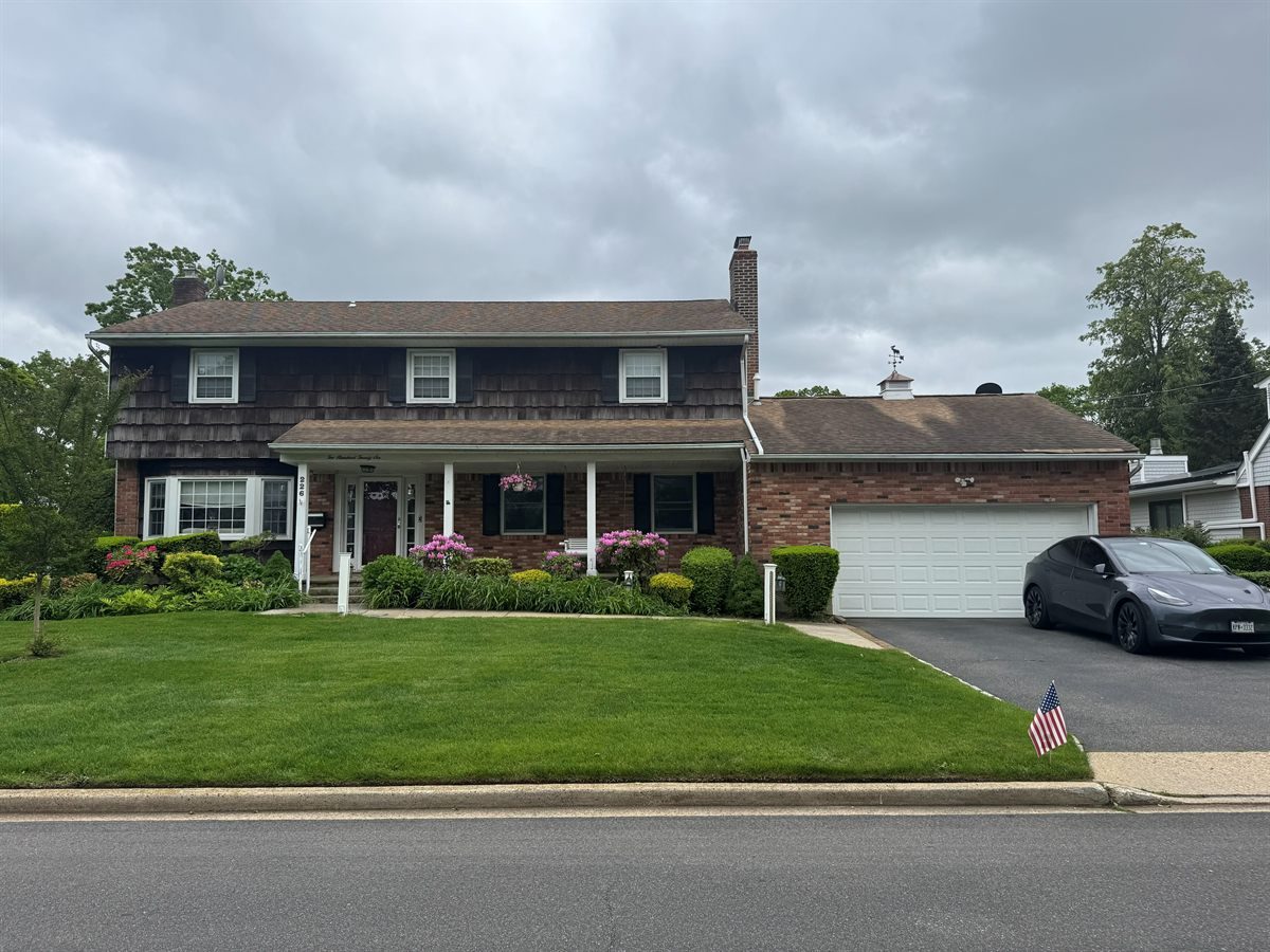 Before: brown cedar-shake and brick colonial with a flat porch roof and worn shingles