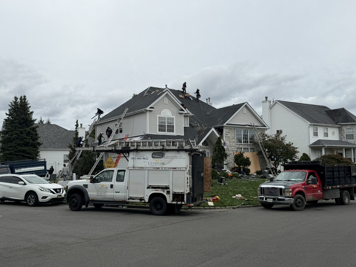 Finished L.I. Taylor job in Holtsville, NY: large two-story colonial with stone veneer and a new charcoal architectural shingle roof, replaced in one day in October 2026