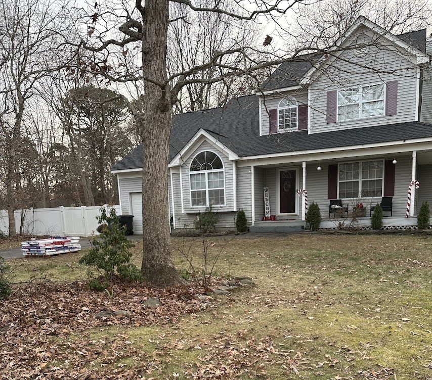 Finished job in Ridge, NY: two-story colonial with a new charcoal architectural shingle roof, replaced in one day in December 2025