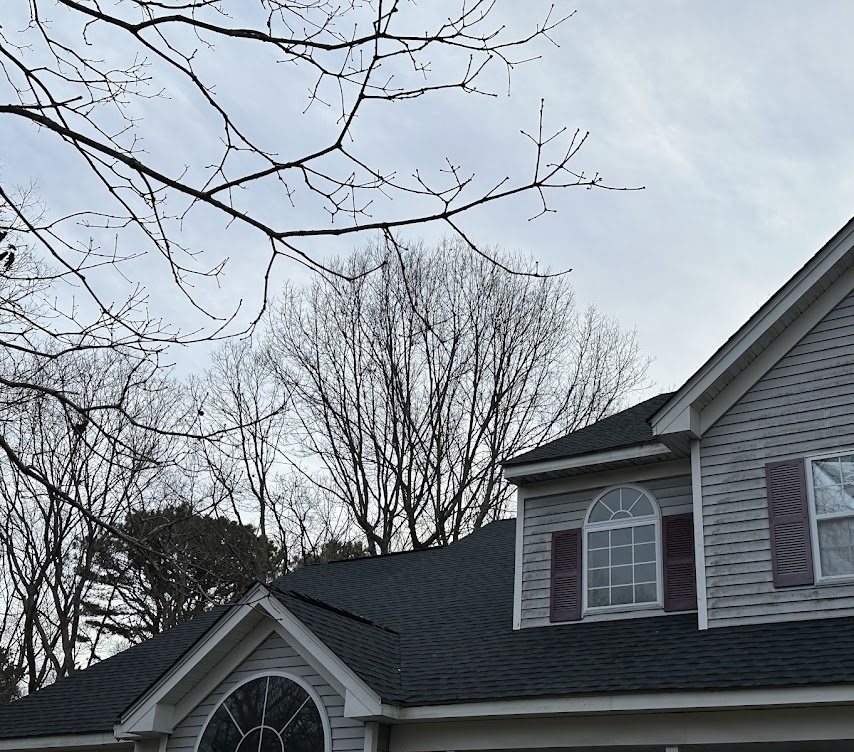 Close view of the same Ridge roof: new architectural shingles on the main roof, dormer and front gable, with clean ridge and valley lines